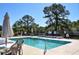 Community pool featuring lounge chairs, umbrellas, and tables for residents to enjoy at 2703 Canvasback Trail, Myrtle Beach, SC 29588