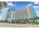 Stunning beachfront condo building boasts balconies and palm trees along the street at 3000 N Ocean Blvd. # 1020, Myrtle Beach, SC 29577
