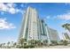 Tall luxury beachfront condo building with a meticulously landscaped entrance at 3000 N Ocean Blvd. # 1020, Myrtle Beach, SC 29577
