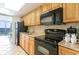 Cozy kitchen featuring wooden cabinetry, granite countertops, and stainless steel appliances at 3000 N Ocean Blvd. # 1020, Myrtle Beach, SC 29577