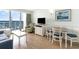 Well-lit living room with ocean view, TV, dining area and sleeper sofa at 3000 N Ocean Blvd. # 1020, Myrtle Beach, SC 29577