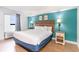 Bedroom with blue accent wall, a king-size bed, and bright natural lighting at 3000 N Ocean Blvd. # 1020, Myrtle Beach, SC 29577
