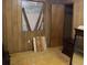A bedroom featuring paneled walls, a window, and some furniture, needing some attention at 317 29Th Ave. N, North Myrtle Beach, SC 29582