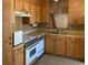 A kitchen showcases wood cabinets, laminate counters, and appliances, needing renovation at 317 29Th Ave. N, North Myrtle Beach, SC 29582