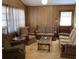 Comfortable living room featuring paneled walls, a coffee table, and matching striped sofas and chairs at 317 29Th Ave. N, North Myrtle Beach, SC 29582
