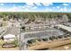 Aerial view of a condo complex featuring spacious parking, surrounding trees, and lush landscaping at 3170 Holmestown Rd., Myrtle Beach, SC 29588