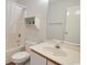 Clean bathroom with a white vanity, toilet, shower/tub, shelf and neutral tile, offering a relaxing space at 3170 Holmestown Rd., Myrtle Beach, SC 29588