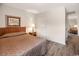 Comfortable bedroom includes a queen bed, wooden floors, a nightstand with lamp, and closet with hallway visible at 3170 Holmestown Rd., Myrtle Beach, SC 29588