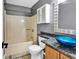 This bathroom has a bathtub with a shower, a toilet, and a blue sink at 3700 Golf Colony Lane # 5J, Little River, SC 29566