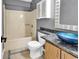 This is a bathroom with unique blue sink, bathtub and updated cabinet at 3700 Golf Colony Lane # 5J, Little River, SC 29566