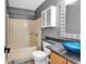 This bathroom has a bathtub with a shower, a toilet, and a unique blue sink at 3700 Golf Colony Lane # 5J, Little River, SC 29566