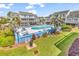 Community pool with lounge chairs surrounded by lush landscaping and community housing at 3700 Golf Colony Lane # 5J, Little River, SC 29566