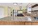 Modern kitchen has stainless appliances, granite counters, a tile backsplash, and under-cabinet lighting at 3700 Golf Colony Lane # 5J, Little River, SC 29566