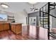 Open living room boasts wood floors, a spiral staircase and views of an outdoor pool from a private balcony at 3700 Golf Colony Lane # 5J, Little River, SC 29566