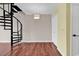 Living room featuring a spiral staircase and a neutral color palette at 3700 Golf Colony Lane # 5J, Little River, SC 29566