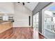 Open living space featuring hardwood floors, kitchen, and access to the patio at 3700 Golf Colony Lane # 5J, Little River, SC 29566