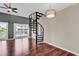 Living room with a spiral staircase and sliding glass doors leading to an outdoor space at 3700 Golf Colony Lane # 5J, Little River, SC 29566
