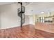 This living room has hard wood floors, a spiral staircase, and adjoins the kitchen at 3700 Golf Colony Lane # 5J, Little River, SC 29566