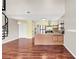 This is a living room with hardwood floors, a spiral staircase and views of the kitchen at 3700 Golf Colony Lane # 5J, Little River, SC 29566