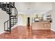 Spacious living area with a spiral staircase, a kitchen island, and hardwood floors at 3700 Golf Colony Lane # 5J, Little River, SC 29566