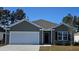 Charming one-story home featuring a 2-car garage, neat landscaping, and neutral color palette at 4488 East Coast Ln., Shallotte, NC 28470