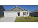 Charming single-Gathering home featuring a well-manicured lawn and an attached garage at 4496 East Coast Ln., Shallotte, NC 28470