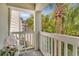 Relaxing balcony view with a chair and a lush palm tree, perfect for enjoying the outdoors at 4601 Greenbriar Dr. # 201, Little River, SC 29566