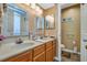 Bathroom with dual sinks, framed mirrors, modern lighting, and a neutral color palette at 4601 Greenbriar Dr. # 201, Little River, SC 29566