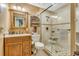 Cozy bathroom with wooden vanity, a step-in glass shower, and neutral colored walls at 4601 Greenbriar Dr. # 201, Little River, SC 29566