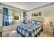 Comfortable bedroom with window, side table, plush bedding, and decor at 4601 Greenbriar Dr. # 201, Little River, SC 29566
