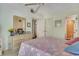 Bedroom with a dresser, ceiling fan, and views into the bathroom at 4601 Greenbriar Dr. # 201, Little River, SC 29566
