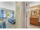 Bedroom with view into the bathroom, window, and blue accents at 4601 Greenbriar Dr. # 201, Little River, SC 29566