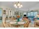 Dining room with a round glass table and seating, which flows into a comfortable living area at 4601 Greenbriar Dr. # 201, Little River, SC 29566