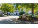 Exterior shot of the condo with lush landscaping and a parking area surrounded by mature trees at 4601 Greenbriar Dr. # 201, Little River, SC 29566