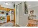 Cozy condo kitchen with ample cabinet space, a white refrigerator, and a view of the hall at 4601 Greenbriar Dr. # 201, Little River, SC 29566
