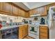 Functional kitchen featuring wood cabinets, essential appliances, and a practical layout at 4601 Greenbriar Dr. # 201, Little River, SC 29566