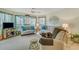 Relaxing living area with plush sofas, natural light, and a ceiling fan for added comfort at 4601 Greenbriar Dr. # 201, Little River, SC 29566