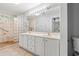 Bright bathroom featuring a double sink vanity, large mirror, and a glass block shower at 4648 Fringetree Dr. # C, Murrells Inlet, SC 29576