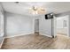 Bedroom featuring wood floors, a ceiling fan, and attached bath/closet access at 4648 Fringetree Dr. # C, Murrells Inlet, SC 29576