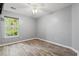 Bedroom with wood-look flooring, a ceiling fan, and a large window providing ample natural light at 4648 Fringetree Dr. # C, Murrells Inlet, SC 29576