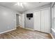 Bright bedroom with wood-look flooring, a ceiling fan, and TV at 4648 Fringetree Dr. # C, Murrells Inlet, SC 29576