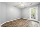 Bright bedroom with wood-look flooring and a door leading to the outdoor space at 4648 Fringetree Dr. # C, Murrells Inlet, SC 29576