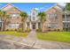 Inviting brick condo with a manicured lawn, mature trees, and an elegant entrance at 4648 Fringetree Dr. # C, Murrells Inlet, SC 29576
