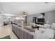 Nicely decorated living room with a modern sectional couch, tile floors, and view of kitchen at 4648 Fringetree Dr. # C, Murrells Inlet, SC 29576