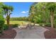 Outdoor patio with a table and chairs overlooks the lush green golf course at 4648 Fringetree Dr. # C, Murrells Inlet, SC 29576