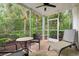 Relaxing screened porch surrounded by lush greenery and palm trees at 4648 Fringetree Dr. # C, Murrells Inlet, SC 29576