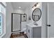 Contemporary bathroom with a black-framed glass shower, modern vanity, and stylish lighting at 48 Half Shell Ct., Litchfield, SC 29585