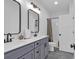 Bathroom with double sinks, grey cabinets, and a shower-tub combination at 48 Half Shell Ct., Litchfield, SC 29585