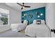 Charming bedroom with a dark accent wall, two twin beds, a ceiling fan, and natural light at 48 Half Shell Ct., Litchfield, SC 29585