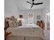 Bright bedroom featuring a wicker headboard, stylish furniture, and access to a bathroom at 48 Half Shell Ct., Litchfield, SC 29585
